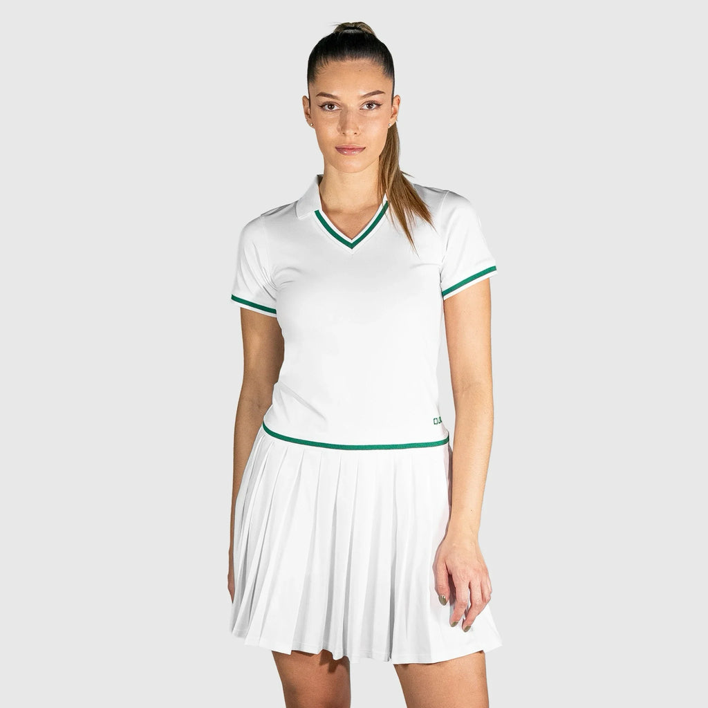 Woman wearing a QUAD Court Padel Dress with green accents on a light gray background