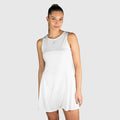 Woman wearing a white QUAD Frame Padel Dress on a light gray background