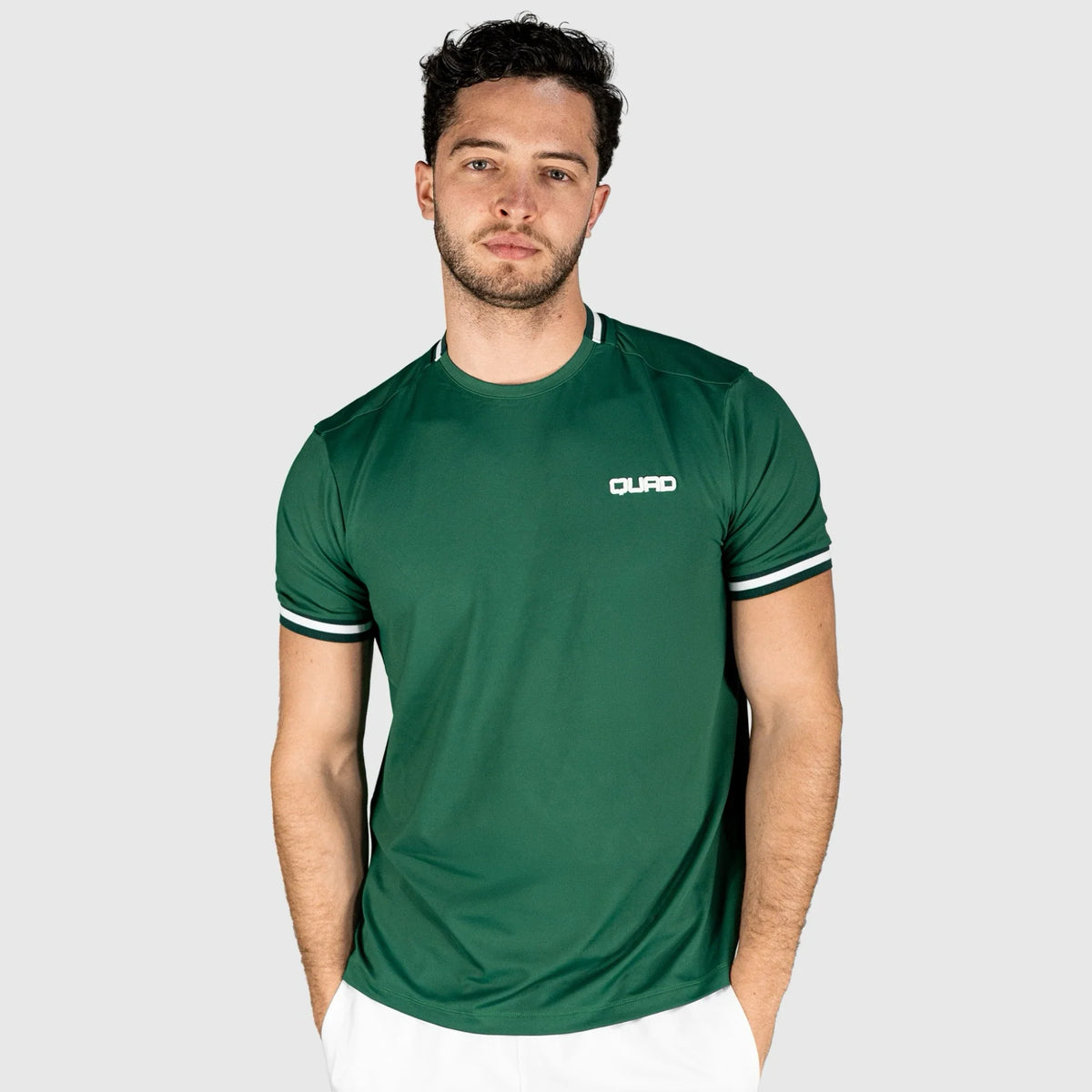 Man wearing a QUAD Match Padel T-shirt green with a brand logo on a white background
