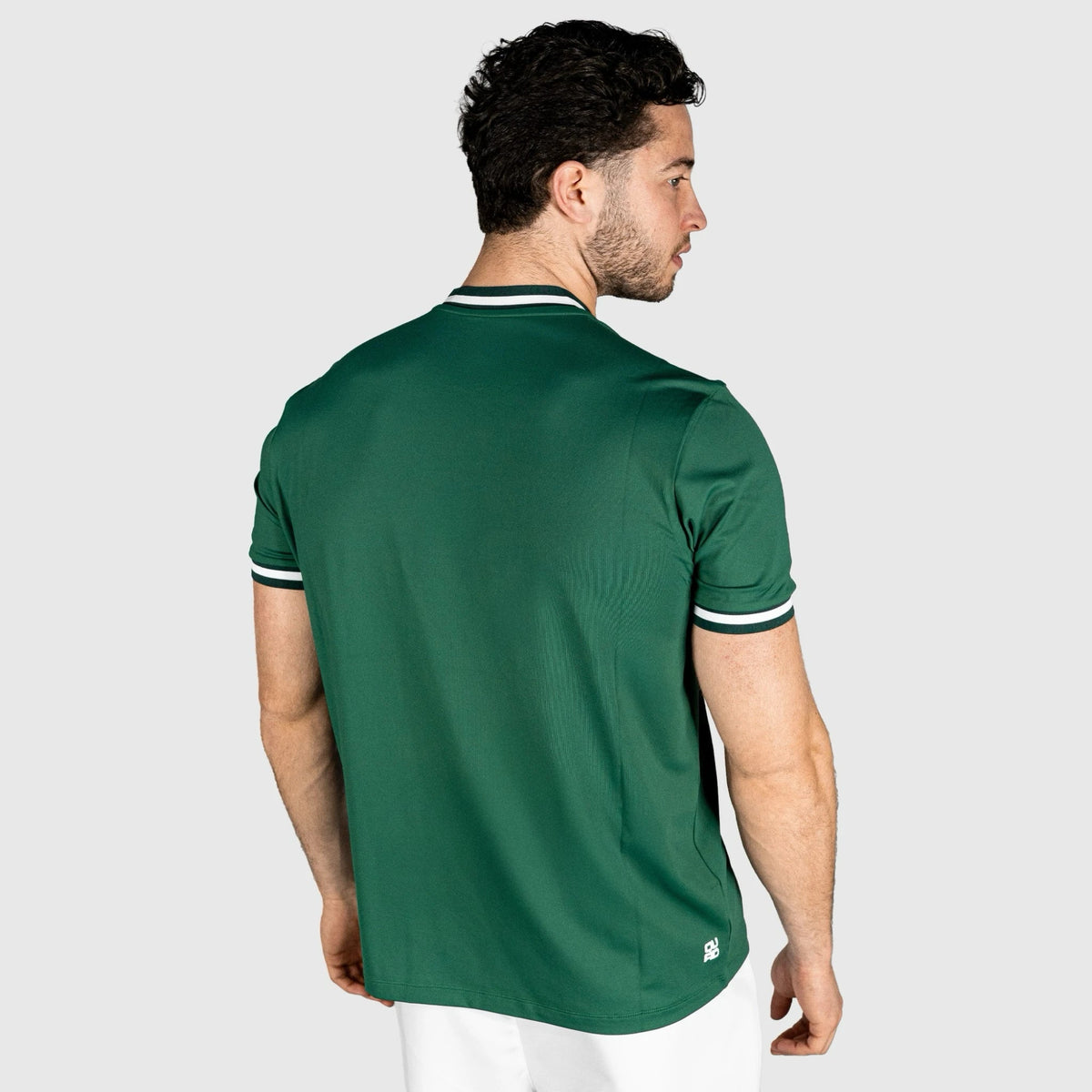 Man wearing QUAD Match Padel T-shirt green on a white background