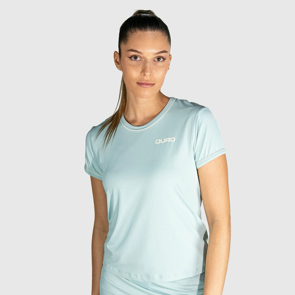 Woman wearing a New Regular Padel shirt with a brand logo on a grey background