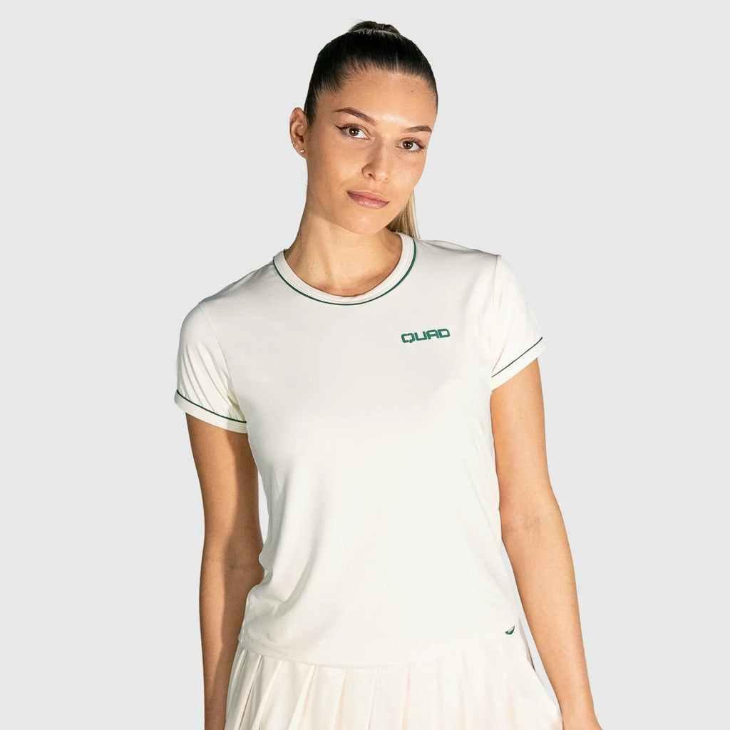 Woman wearing a New Regular Padel shirt  with a brand logo on a light gray background