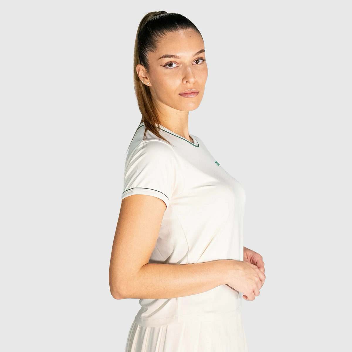 Woman wearing a New Regular Padel shirt with a logo on a light grey background