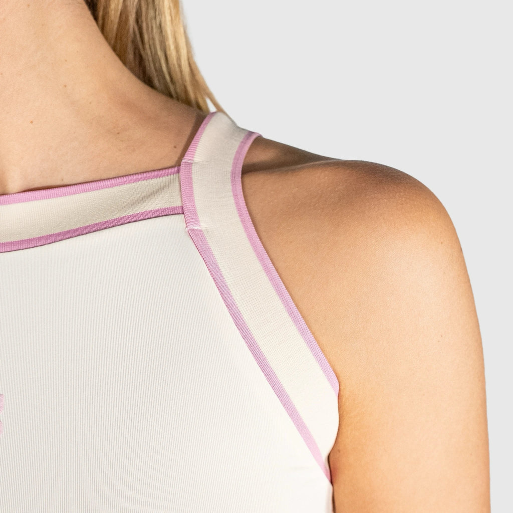Close-up of a person slice padel top tank top with pink straps on a light grey background